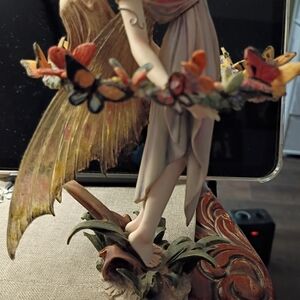 Elegant Fairy Sculpture with Orange and Gold Butterfly Garland